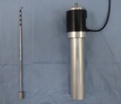 Two components of the probing device in the current study. The left one is the probe with a half size. Four black marked parts in the tip of the probe to measure a distance of tissues on the monitor. The distance of each part is 5 mm. The right one is the main component to measure the force. 3-axis load cell is embedded in the black measurement part. The grip part is connected with the measurement part.